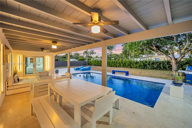 a living room with furniture and a floor to ceiling window