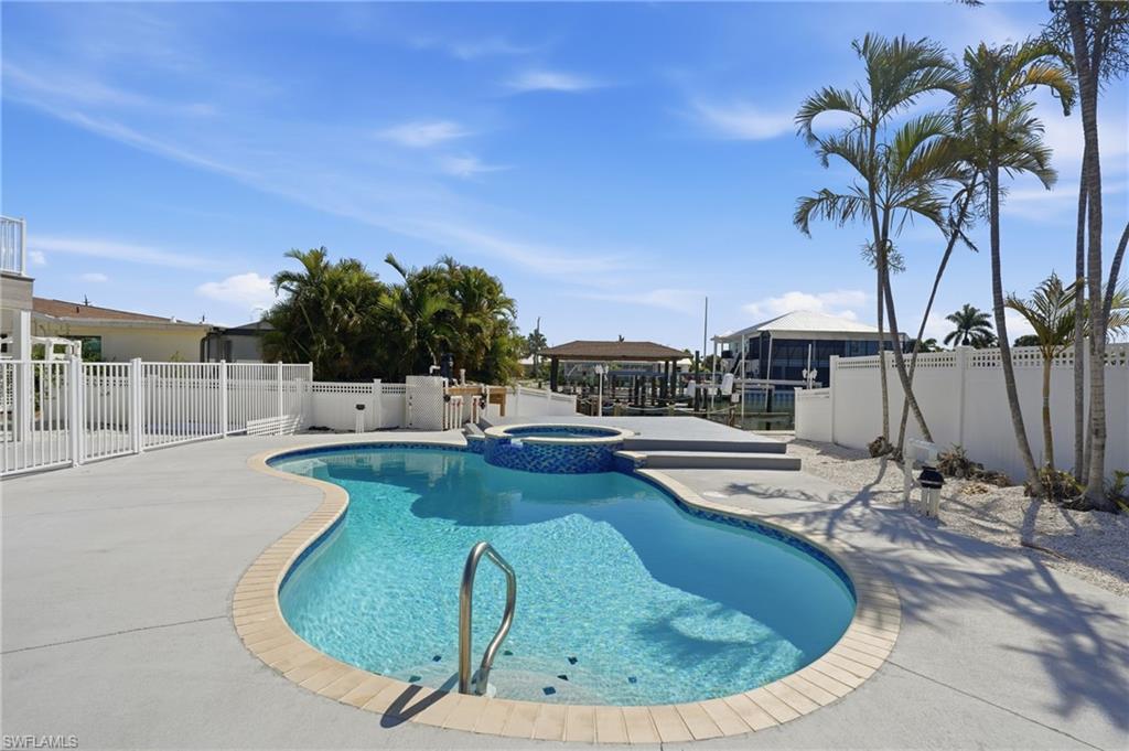 1 Fairview Boulevard Fort Myers Beach, FL 33931 - Photo 4 of 48 a view of a swimming pool with a lounge chair