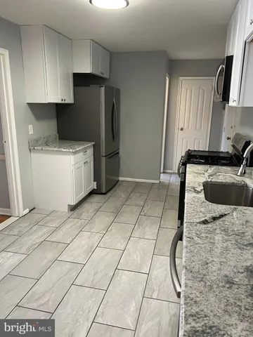 a kitchen with a sink a stove and refrigerator