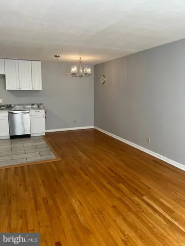 an empty room with kitchen view
