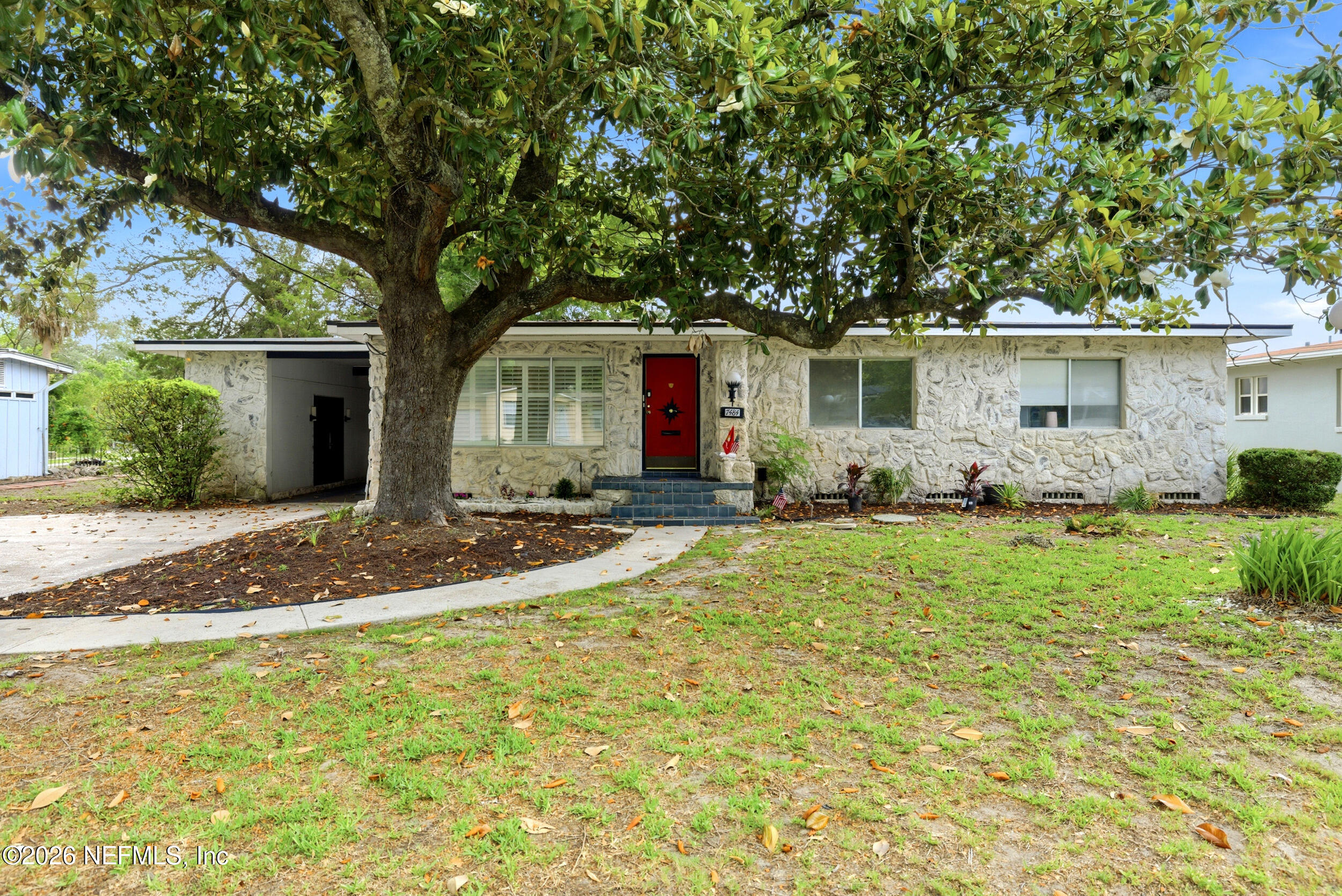7484 Spinola Road Jacksonville, FL 32217 - Photo 6 of 63 a front view of house with yard and trees around