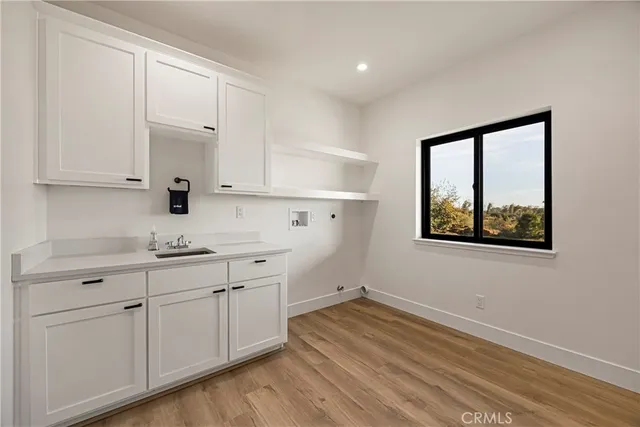 a kitchen with a sink cabinets and window