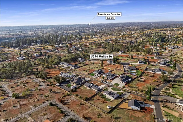 an aerial view of residential building with parking