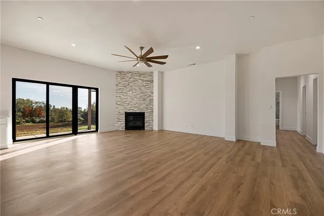 a view of an empty room with a fireplace and a large window