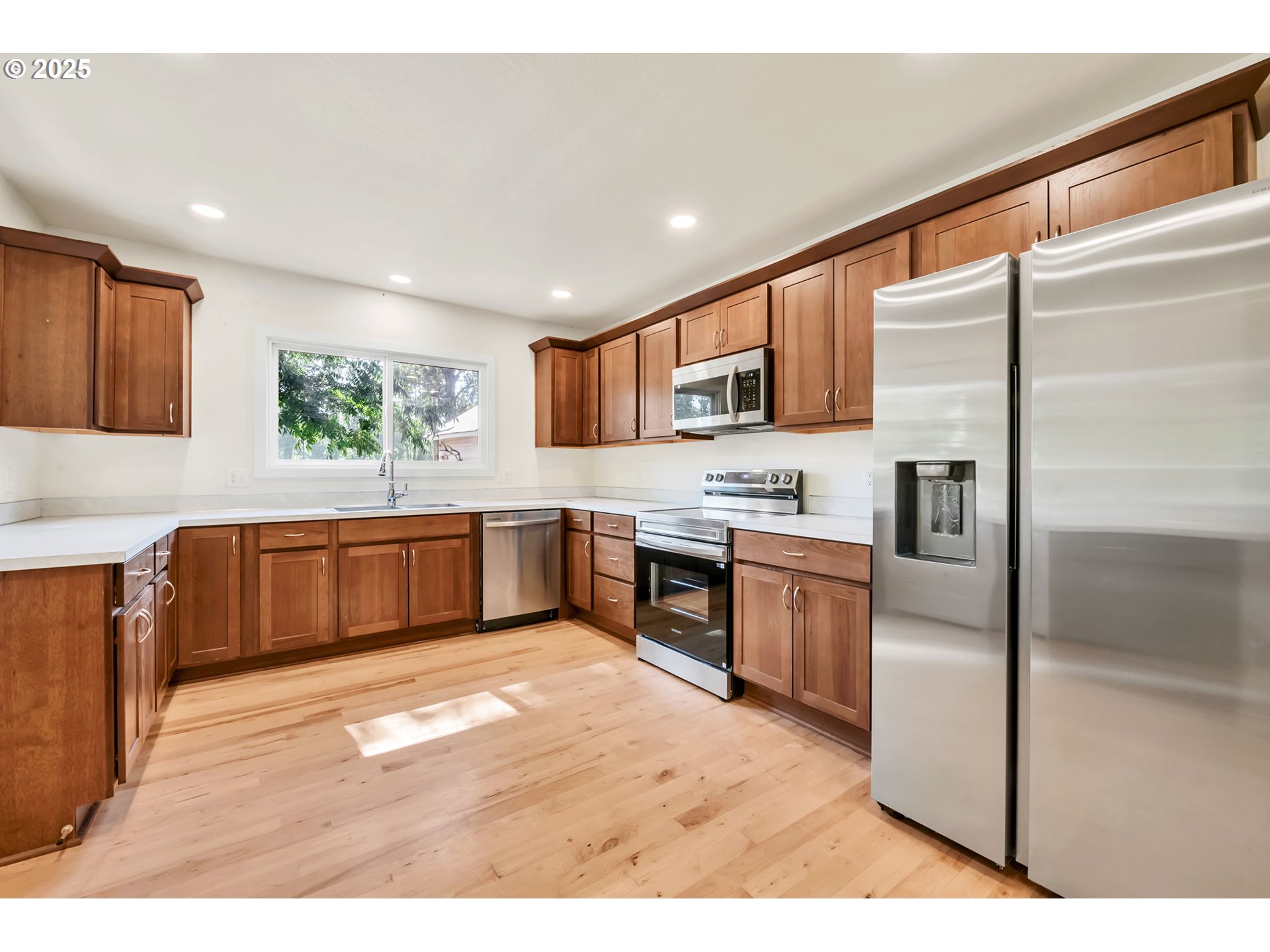 38286 Camp Creek Road Springfield, OR 97478 - Photo 6 of 48 a kitchen with stainless steel appliances kitchen island granite countertop a refrigerator and a stove top oven