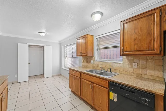 a kitchen with a sink cabinets and window