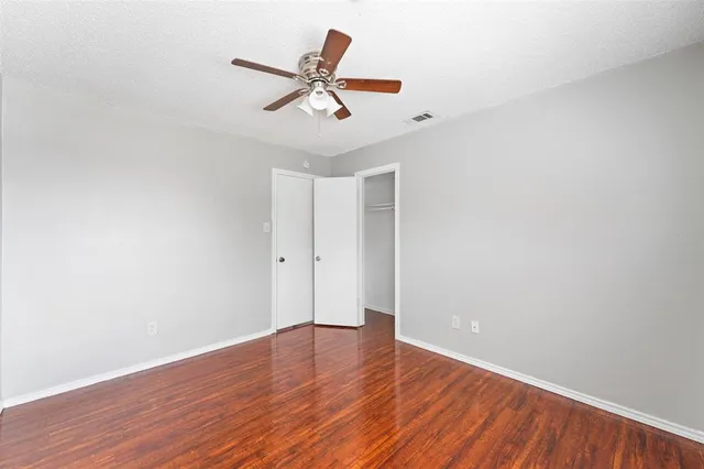 a view of a big room with wooden floor and closet