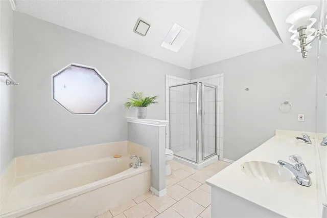 a bathroom with a tub a sink and a mirror