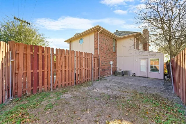 a view of a backyard with wooden fence