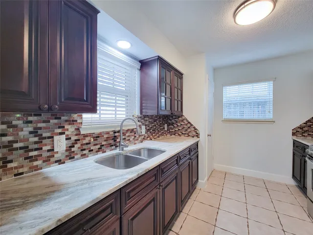a kitchen with a sink and cabinets