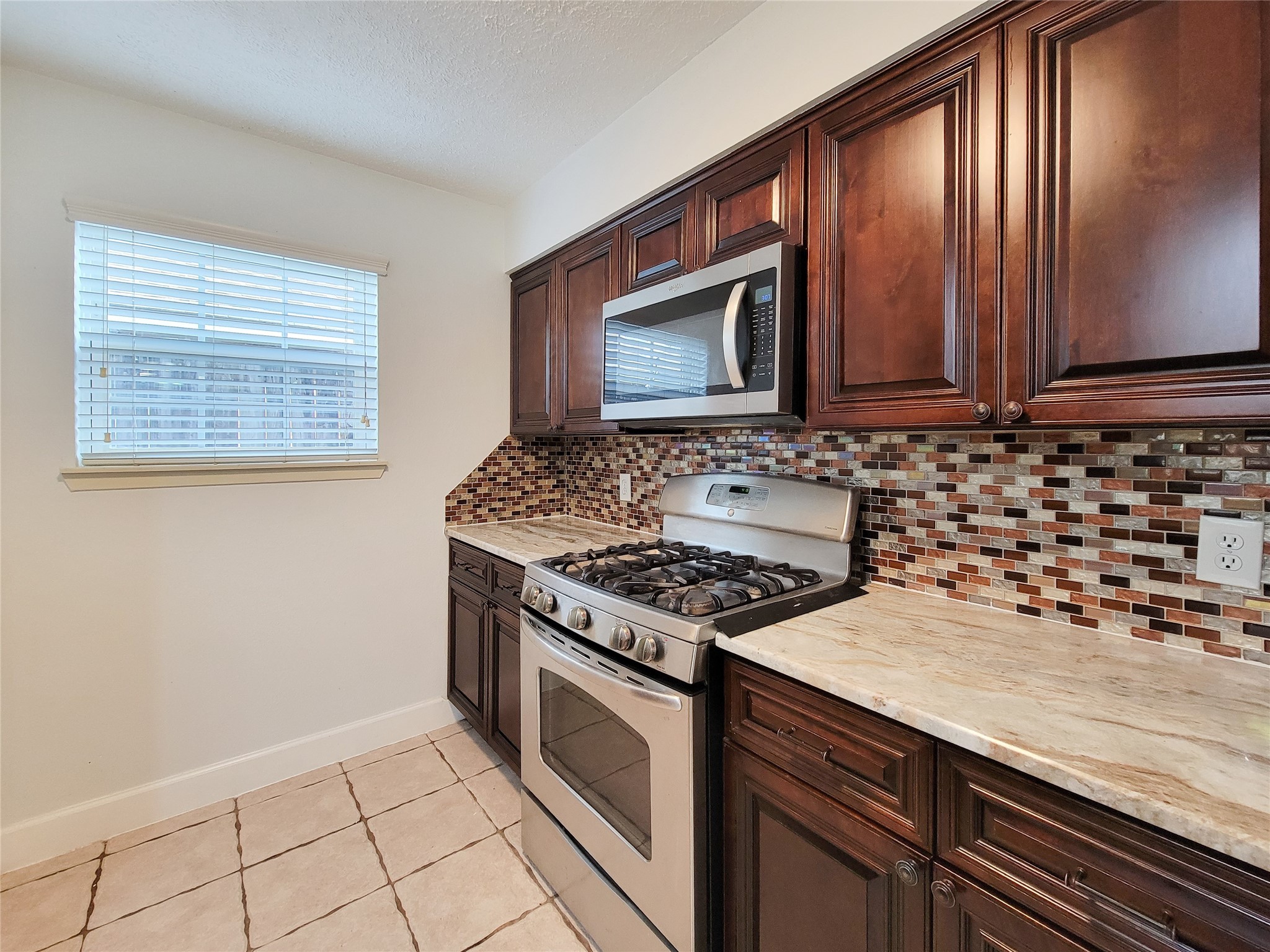 3434 Almondwood Drive Spring, TX 77389 - Photo 13 of 37 a kitchen with a stove and a microwave