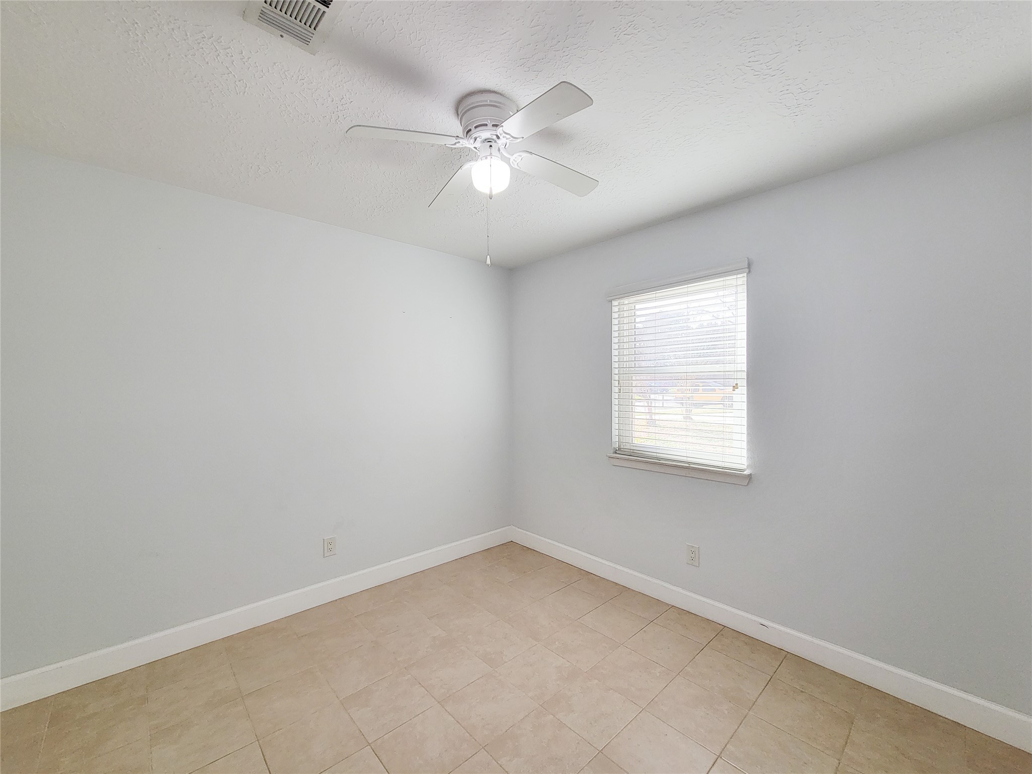 3434 Almondwood Drive Spring, TX 77389 - Photo 17 of 37 an empty room with a window and a fan