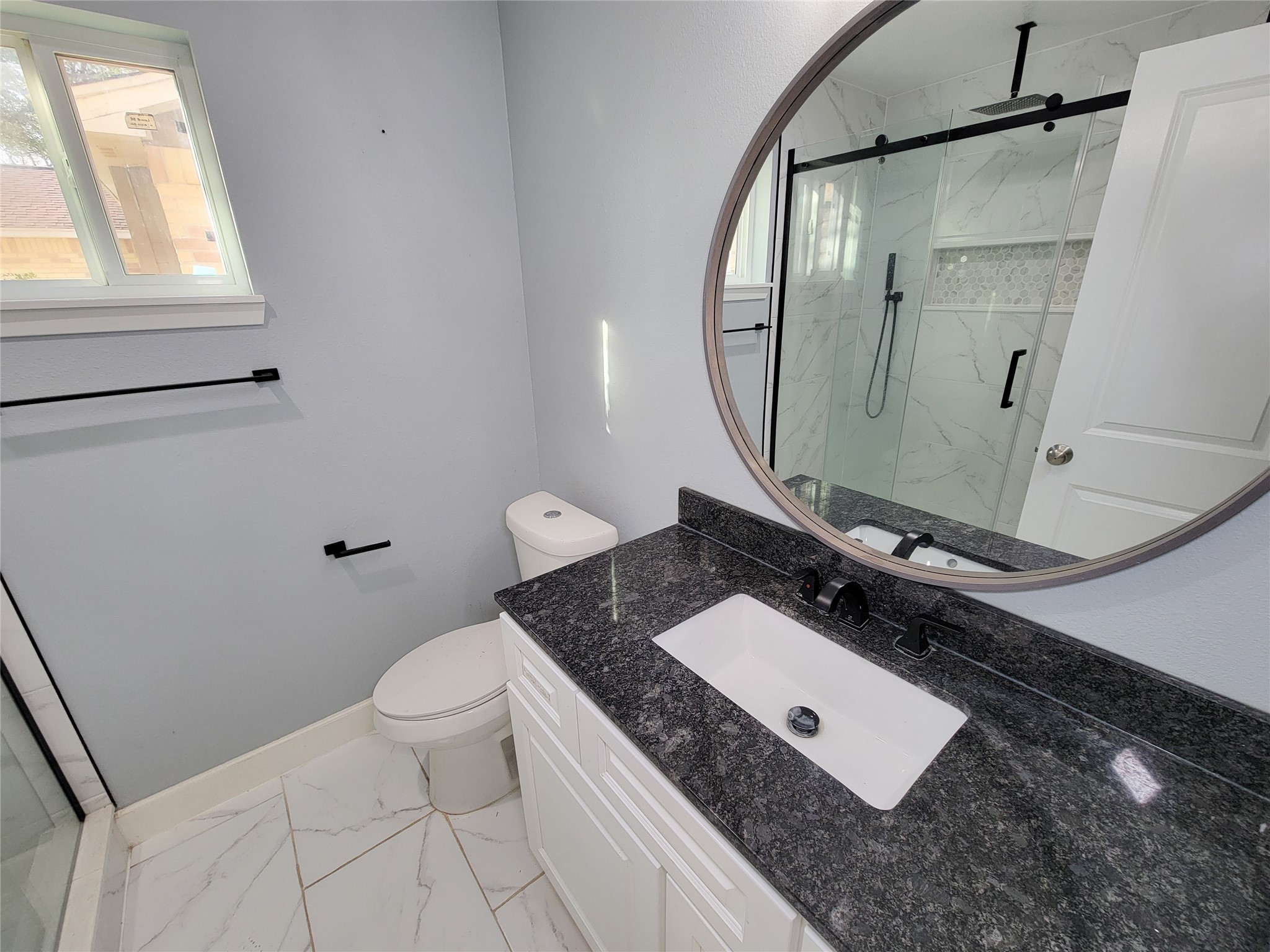 3434 Almondwood Drive Spring, TX 77389 - Photo 19 of 37 a bathroom with a granite countertop sink toilet and mirror