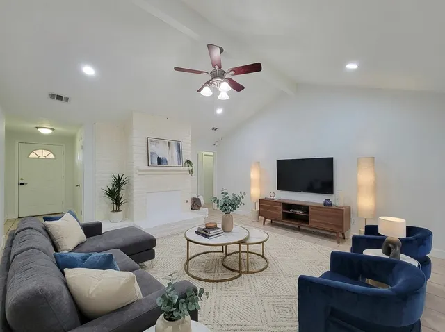 a living room with furniture and a flat screen tv