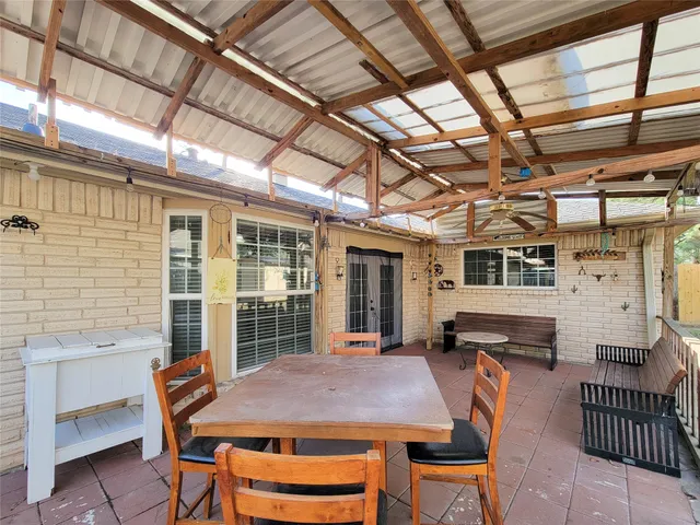 a view of a patio with table and chairs