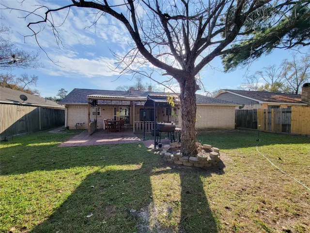 a view of a house with backyard and sitting area
