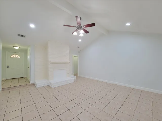 an empty room with closet and fan