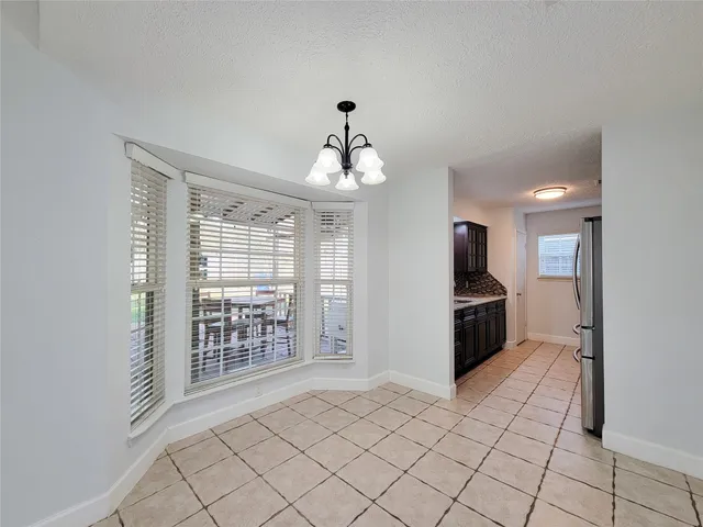 a kitchen with stainless steel appliances a refrigerator and a stove top oven