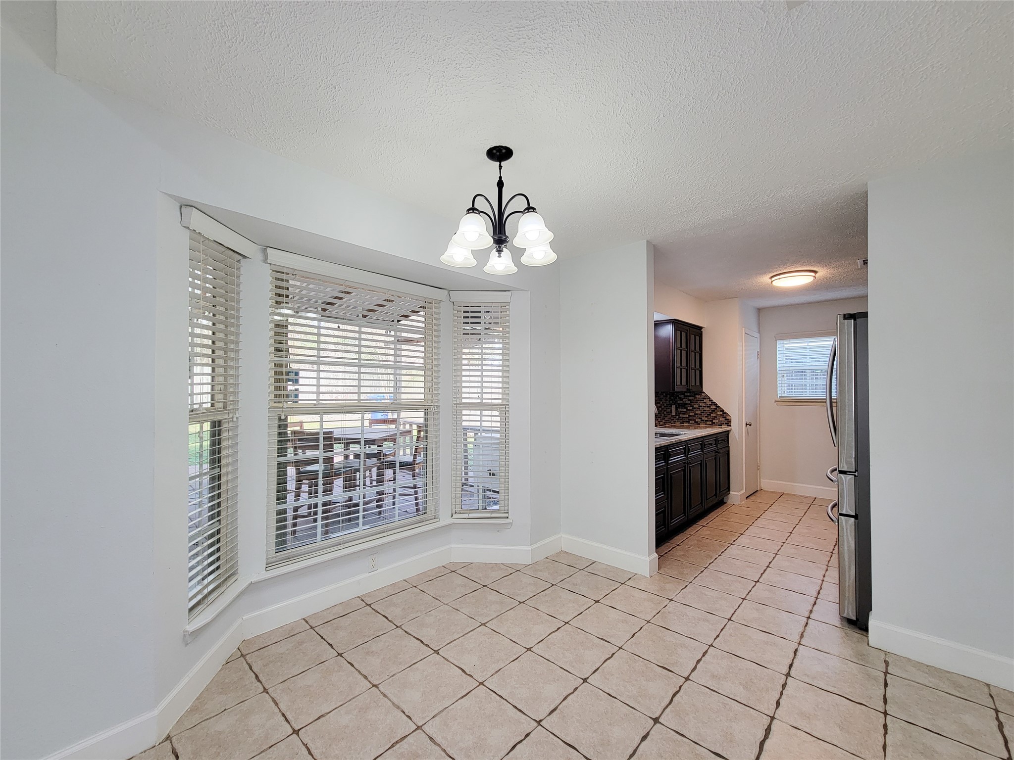 3434 Almondwood Drive Spring, TX 77389 - Photo 9 of 37 a kitchen with stainless steel appliances a refrigerator and a stove top oven