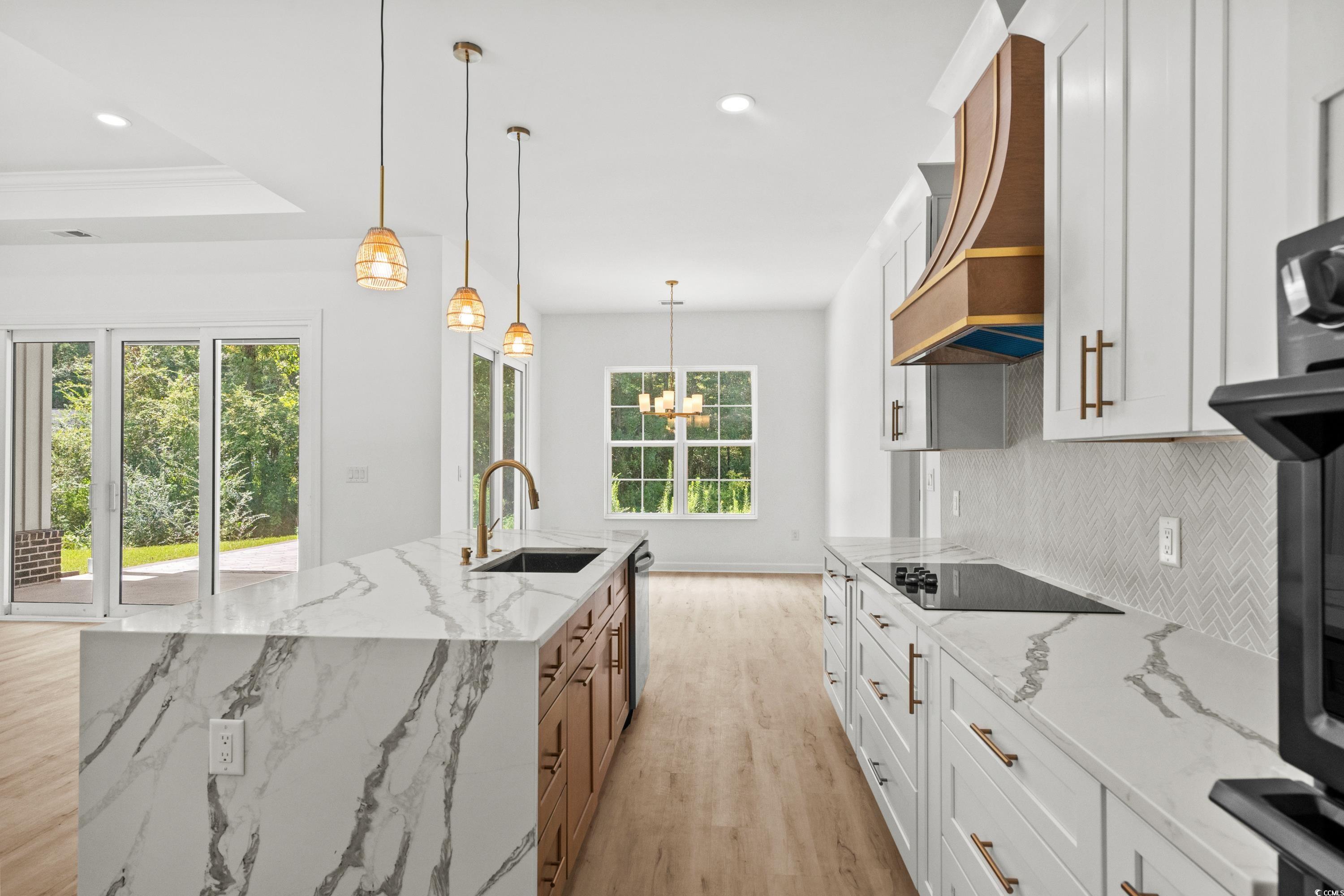 232 Ole Maple Street Loris, SC 29569 - Photo 12 of 40 Kitchen featuring white cabinetry, light stone countertops, decorative light fixtures, light wood-style floors, and recessed lighting