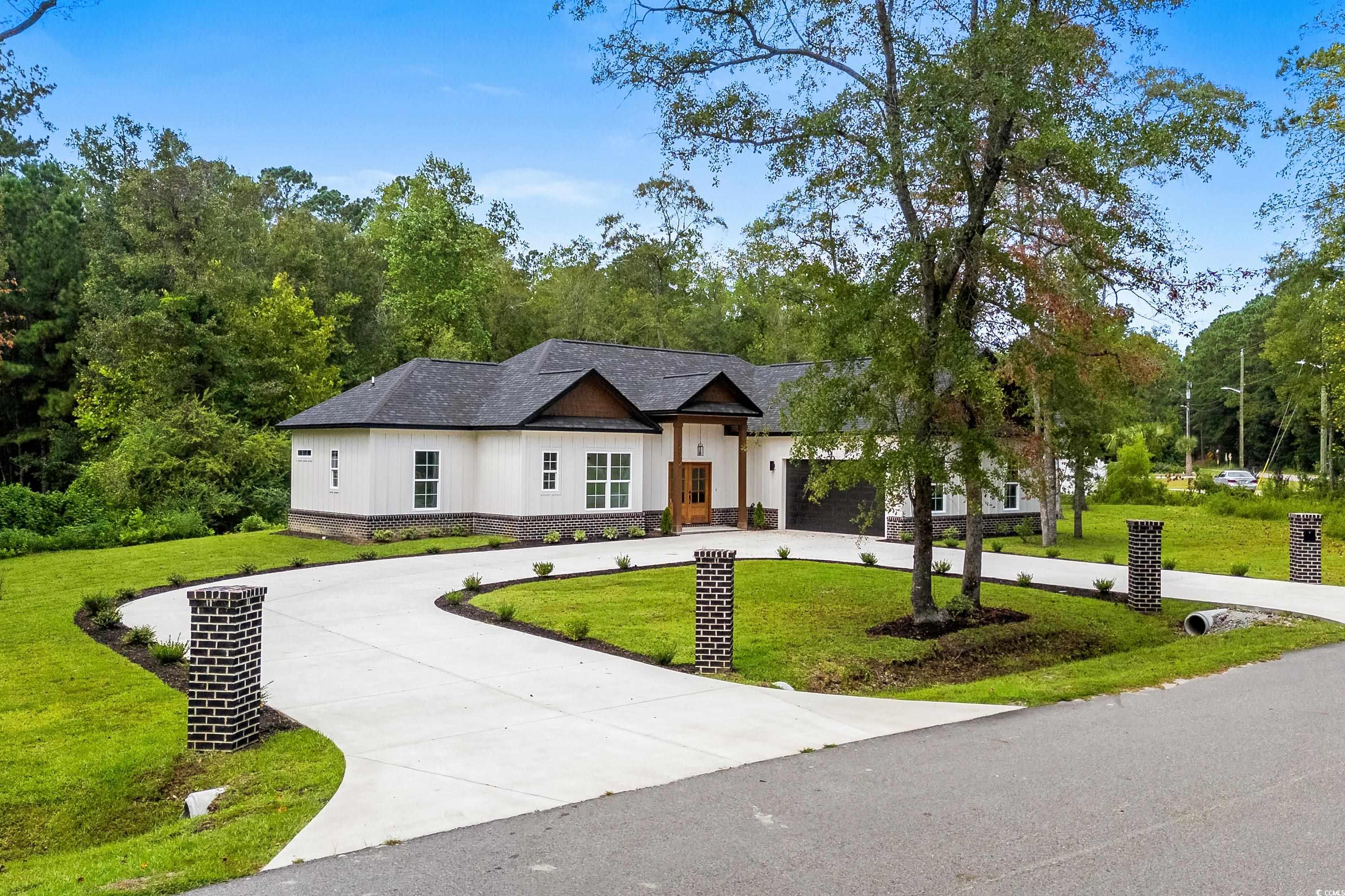 232 Ole Maple Street Loris, SC 29569 - Photo 2 of 40 Modern inspired farmhouse featuring curved driveway, a front yard, and board and batten siding
