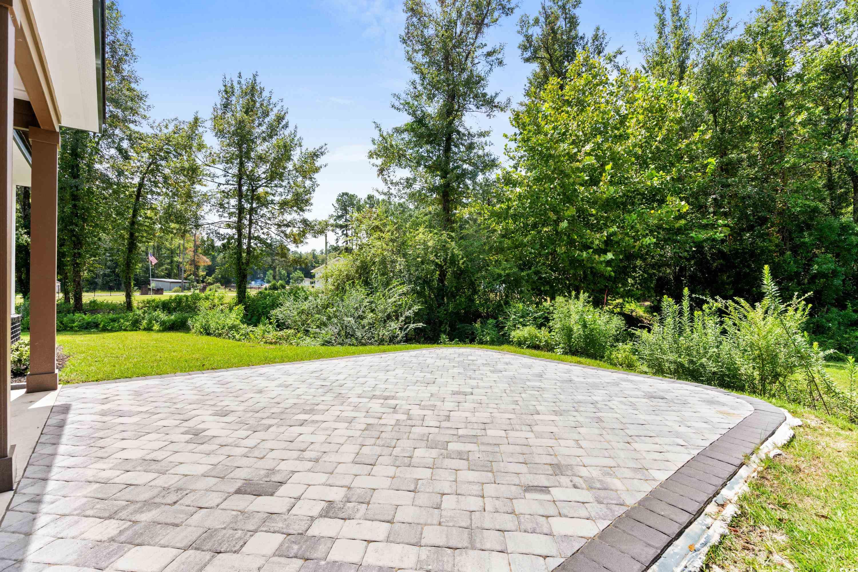 232 Ole Maple Street Loris, SC 29569 - Photo 19 of 40 View of property's community with a patio area, a yard, and view of scattered trees