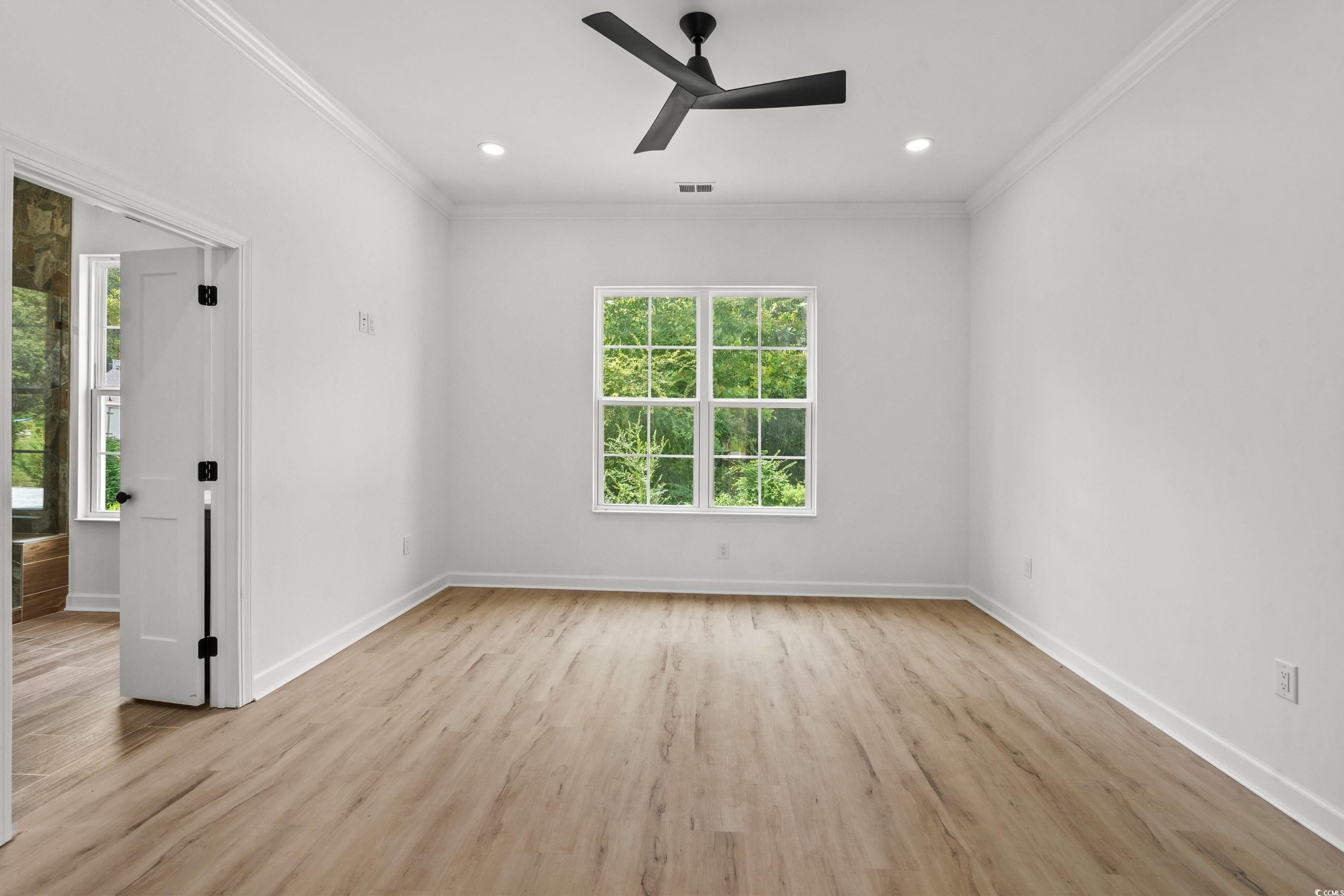 232 Ole Maple Street Loris, SC 29569 - Photo 25 of 40 Empty room featuring light wood-style floors, a ceiling fan, crown molding, and recessed lighting