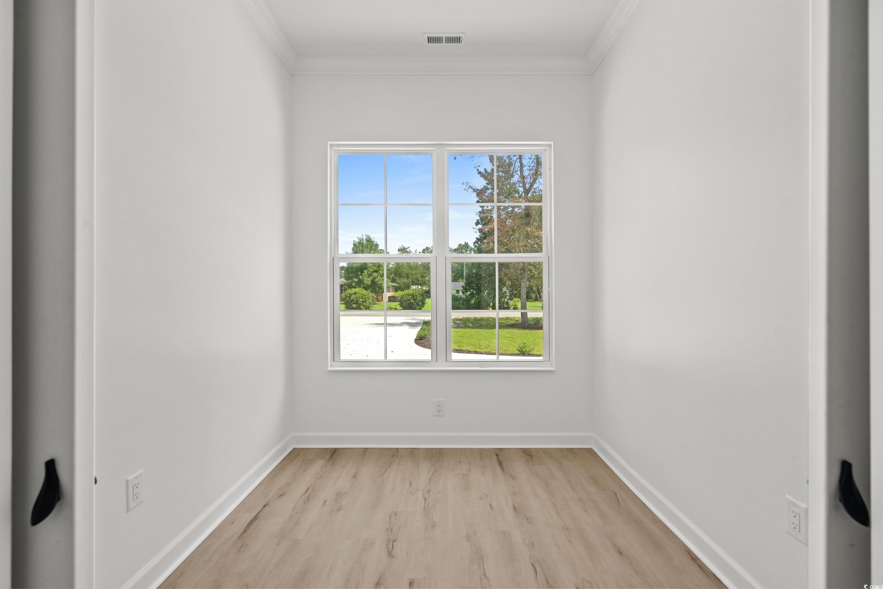 232 Ole Maple Street Loris, SC 29569 - Photo 27 of 40 Spare room with ornamental molding and light wood-style flooring