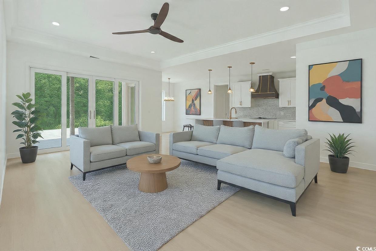 232 Ole Maple Street Loris, SC 29569 - Photo 5 of 39 Living room with light wood-style floors, ceiling fan, and crown molding