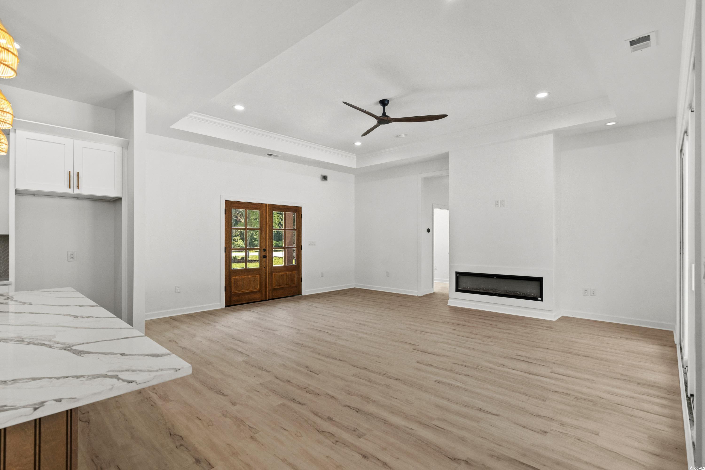 232 Ole Maple Street Loris, SC 29569 - Photo 5 of 40 Unfurnished living room with a raised ceiling, recessed lighting, a fireplace, light wood-style flooring, and ceiling fan