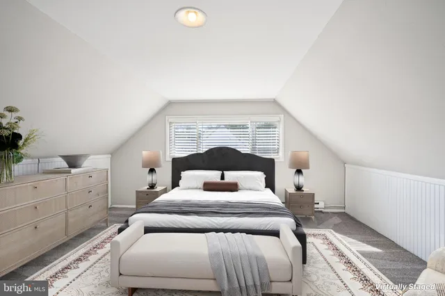 a bedroom with a bed and a potted plant