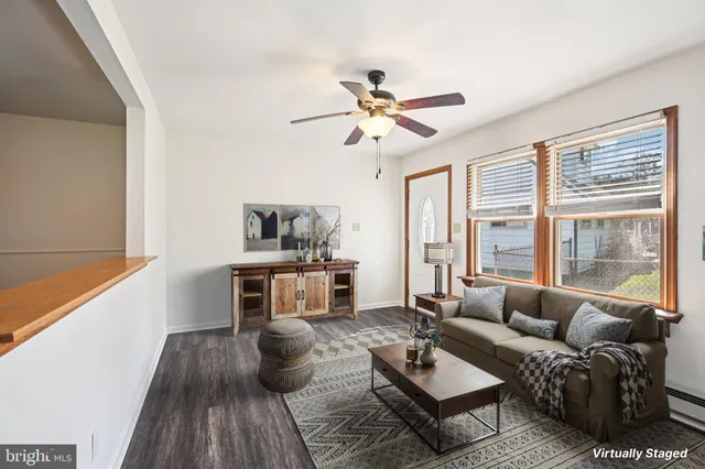 a view of a room with wooden floor fan and a window