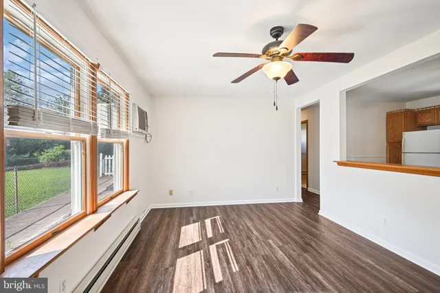 a kitchen with stainless steel appliances granite countertop a refrigerator a microwave oven a sink and dishwasher with wooden floor