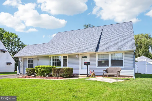 front view of a house with a yard and a fountain