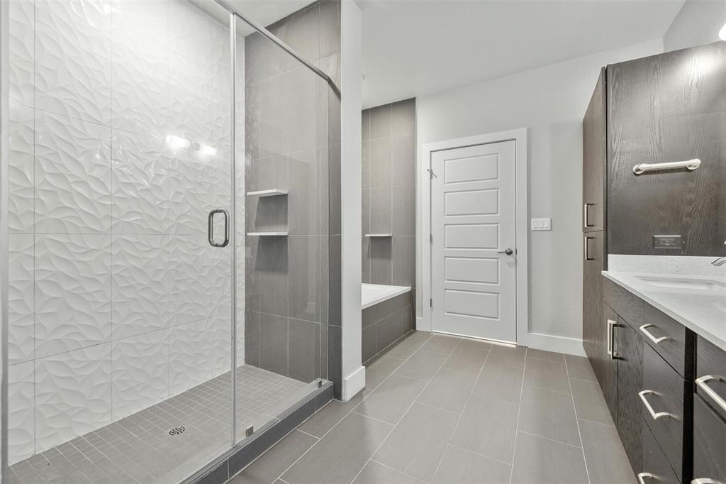 3114 South Congress Avenue, Unit 302 Austin, TX 78704 - Photo 15 of 28 a bathroom with a granite countertop sink mirror and shower
