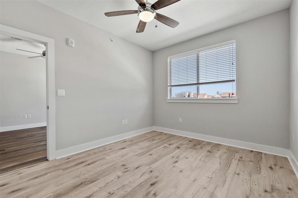 3114 South Congress Avenue, Unit 302 Austin, TX 78704 - Photo 17 of 28 a view of an empty room with wooden floor and a window
