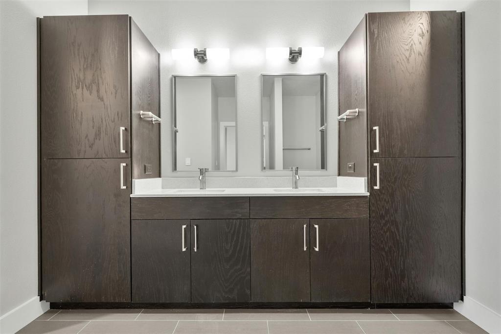 3114 South Congress Avenue, Unit 302 Austin, TX 78704 - Photo 21 of 28 a bathroom with a double vanity sink and a mirror