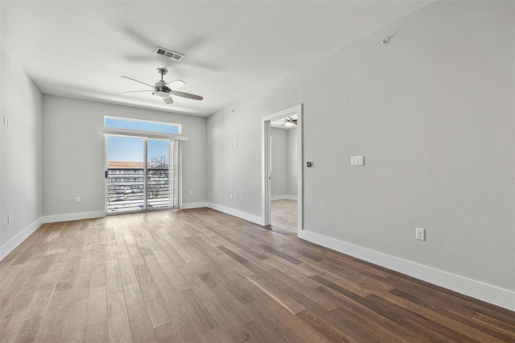 3114 South Congress Avenue, Unit 302 Austin, TX 78704 - Photo 7 of 28 a view of an empty room with wooden floor and a window