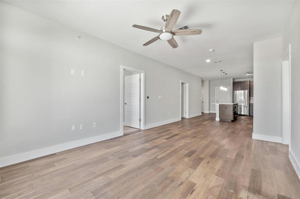 3114 South Congress Avenue, Unit 302 Austin, TX 78704 - Photo 8 of 28 a view of a livingroom with a ceiling fan and wooden floor