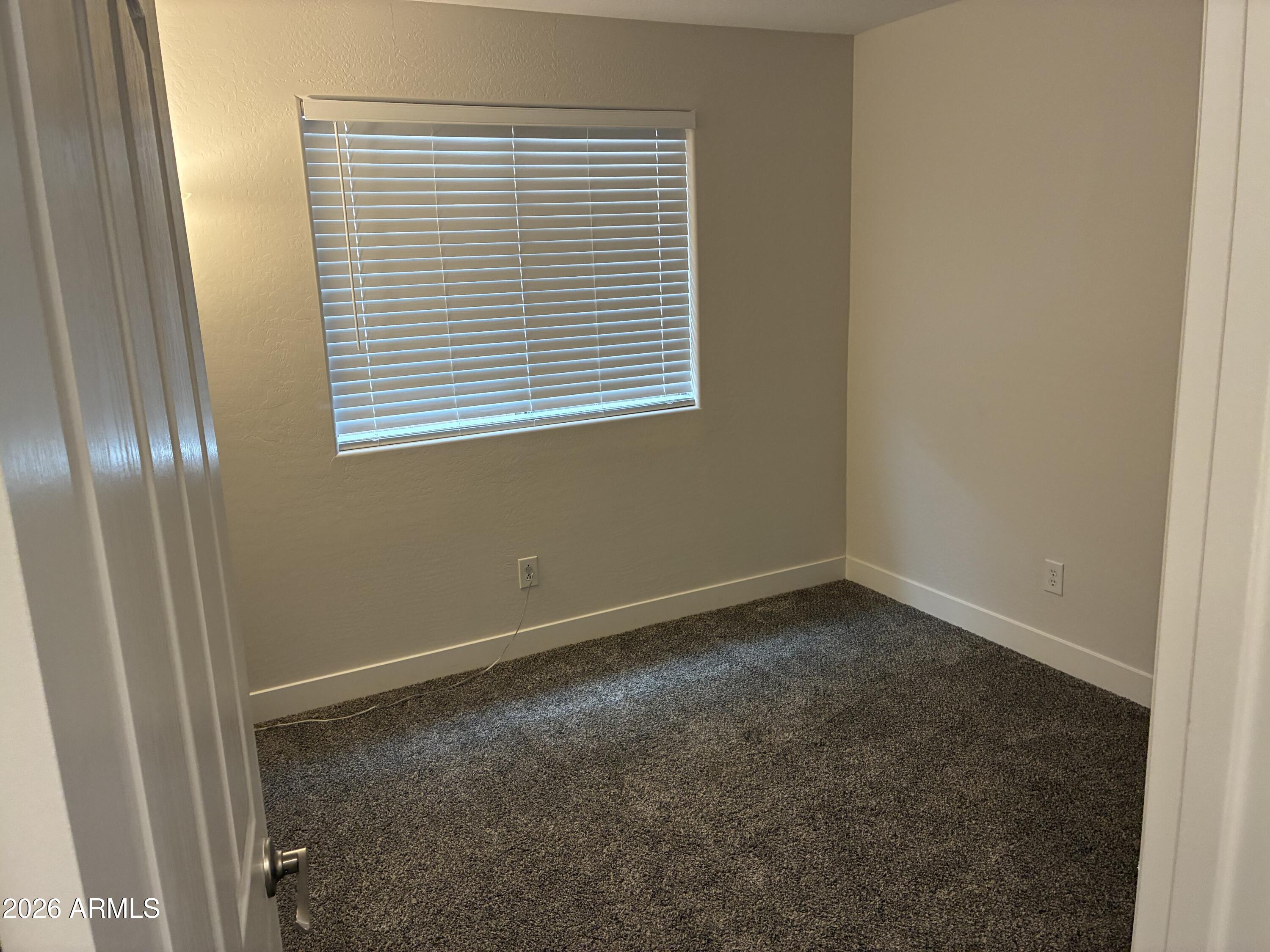 4634 West Fremont Rd. Laveen, AZ 85339 - Photo 18 of 46 a view of an empty room with a window