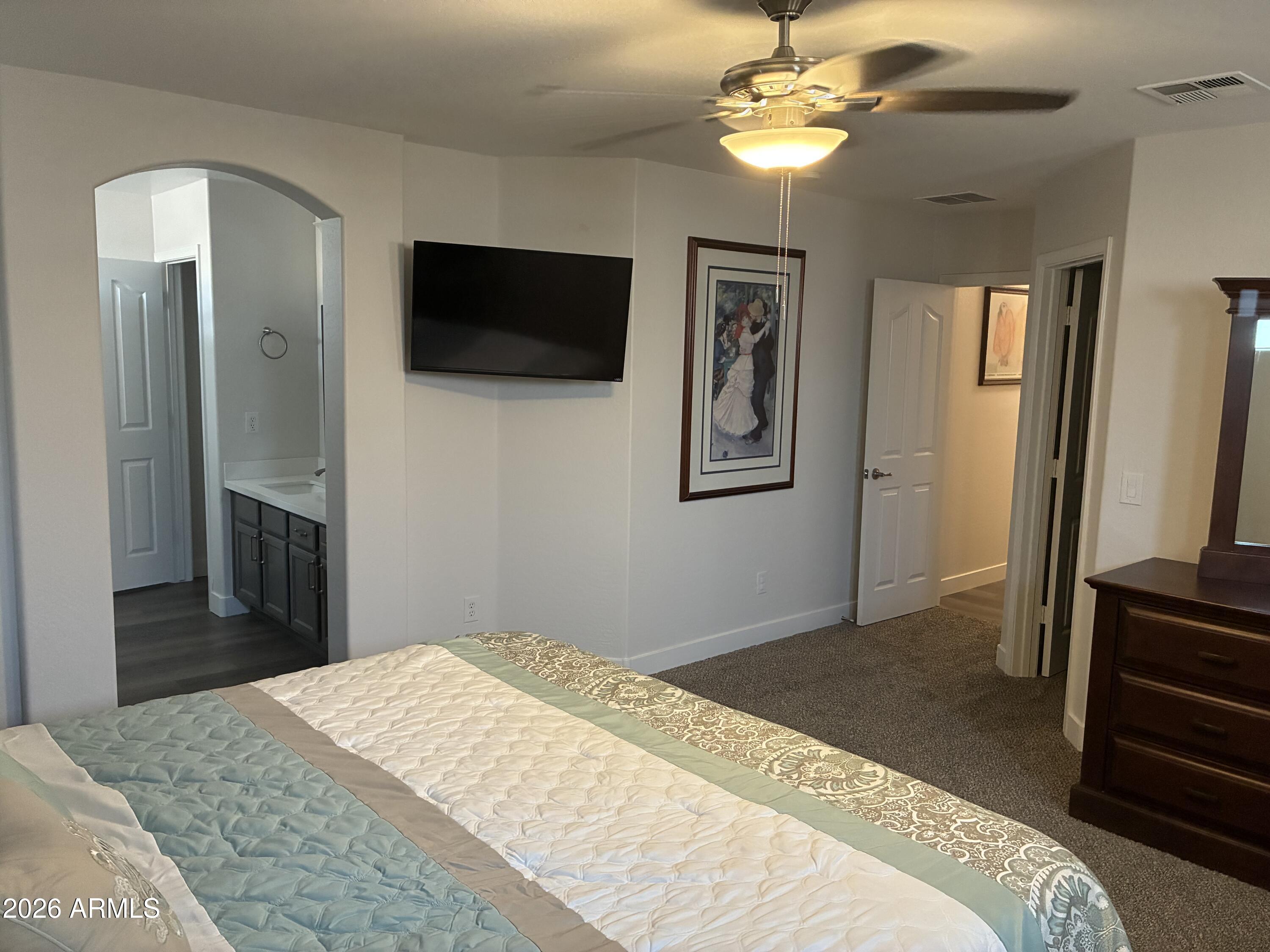 4634 West Fremont Rd. Laveen, AZ 85339 - Photo 22 of 46 a bedroom with a bed and a flat screen tv