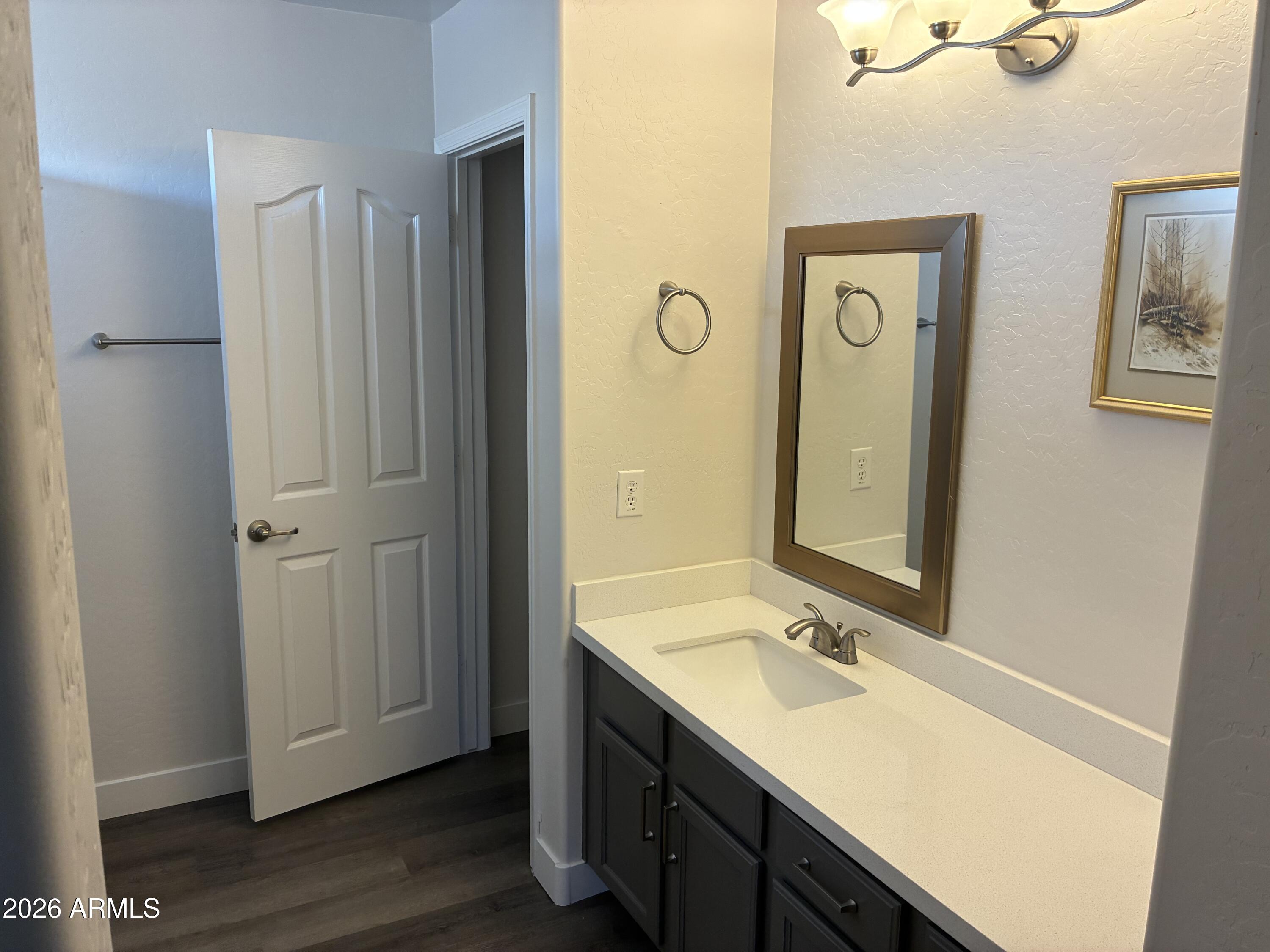 4634 West Fremont Rd. Laveen, AZ 85339 - Photo 25 of 46 a bathroom with a sink a mirror and a shower