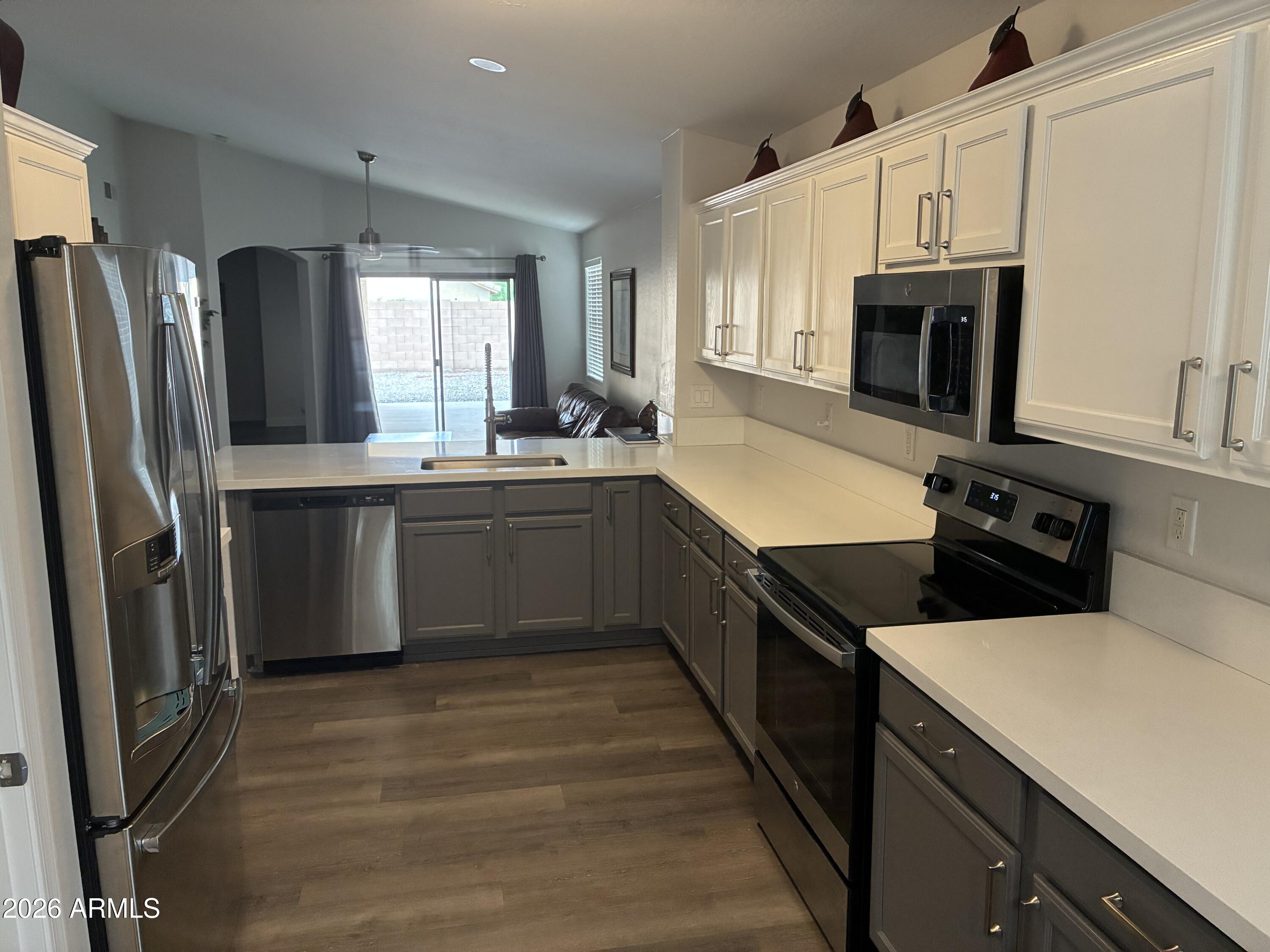 4634 West Fremont Rd. Laveen, AZ 85339 - Photo 7 of 46 a kitchen with stainless steel appliances a sink stove refrigerator and cabinets
