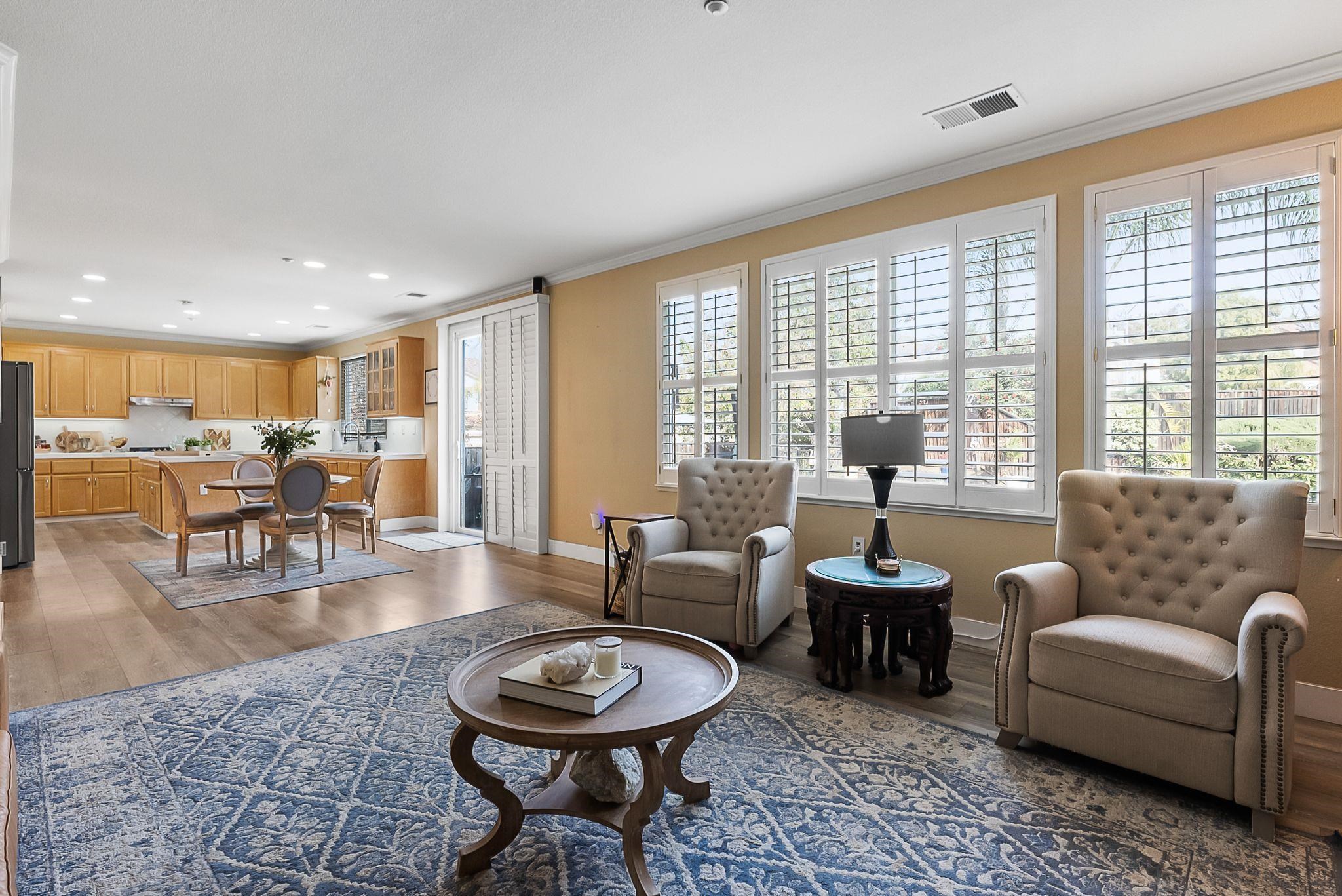 606 Ralston Court Brentwood, CA 94513 - Photo 11 of 32 Living room with dark wood-type flooring, crown molding, and recessed lighting