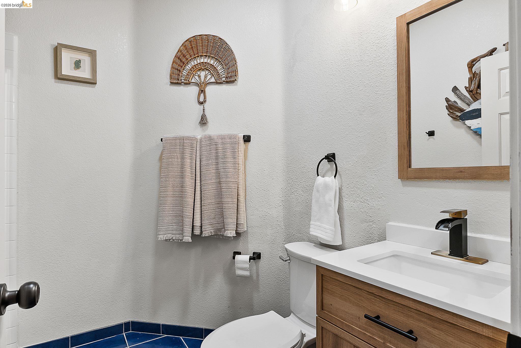 606 Ralston Court Brentwood, CA 94513 - Photo 13 of 32 a bathroom with a sink a toilet and mirror