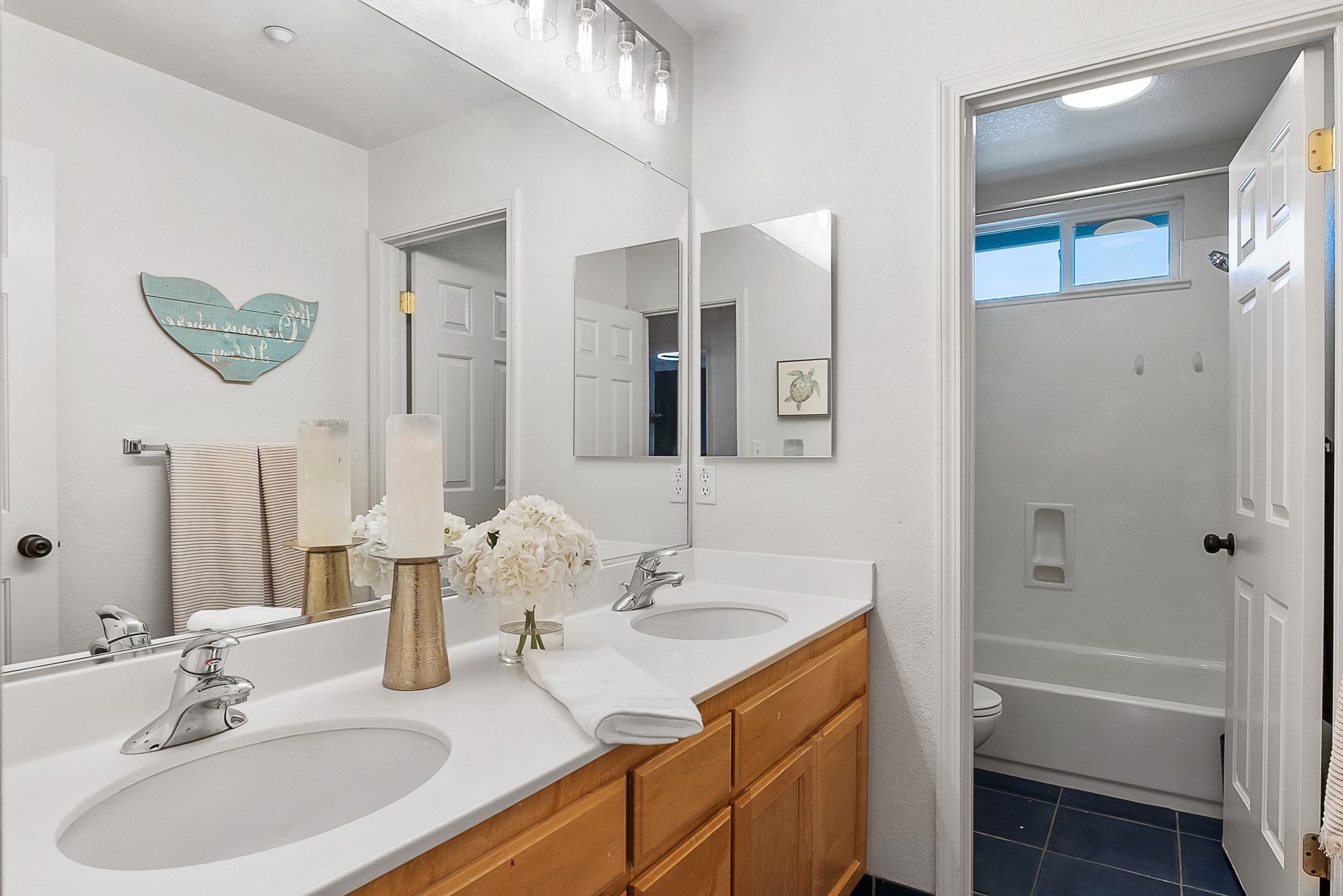 606 Ralston Court Brentwood, CA 94513 - Photo 15 of 32 Full bathroom featuring double vanity, bathing tub / shower combination, and dark tile patterned floors