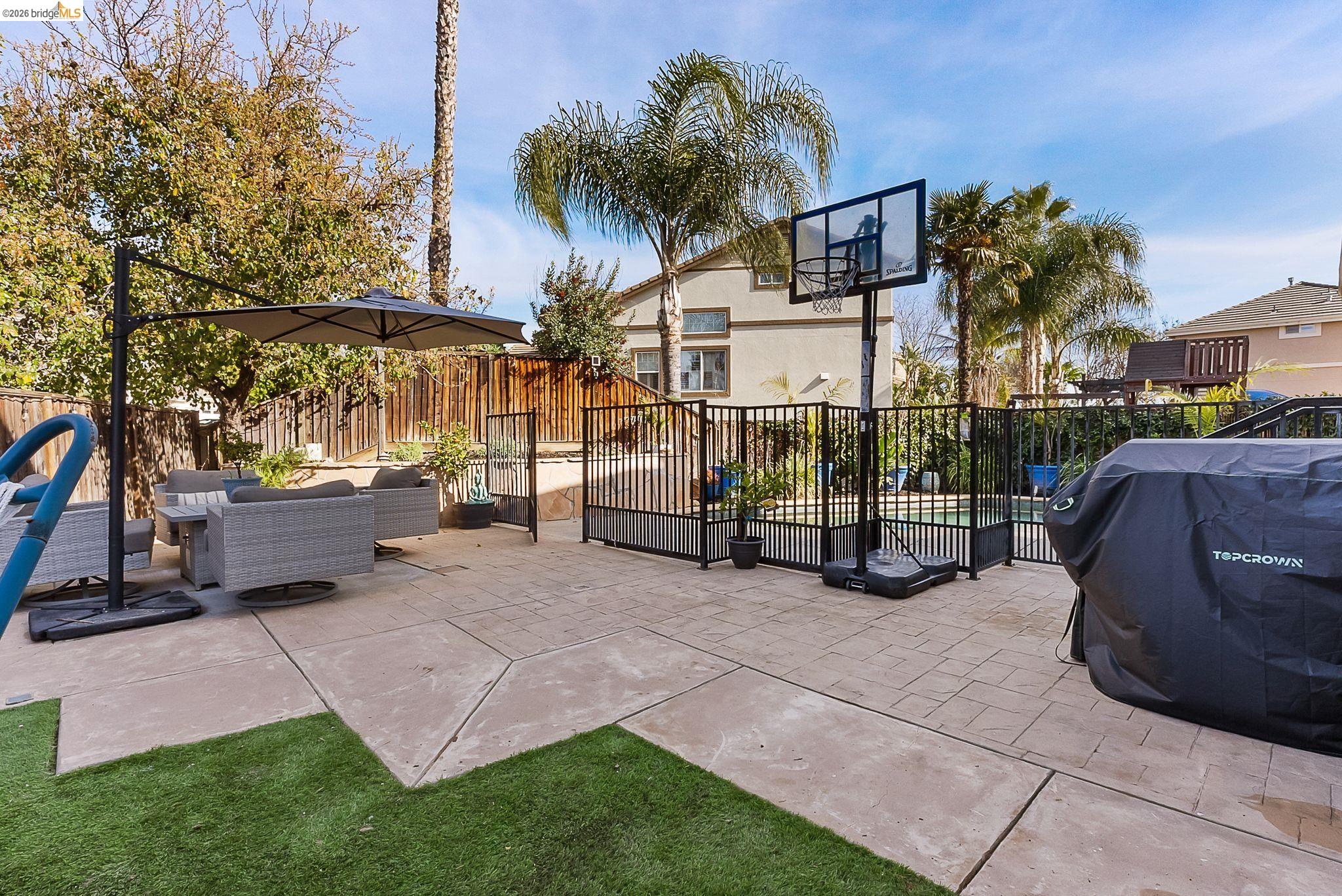 606 Ralston Court Brentwood, CA 94513 - Photo 27 of 32 a view of a chair and table in the back yard of the house