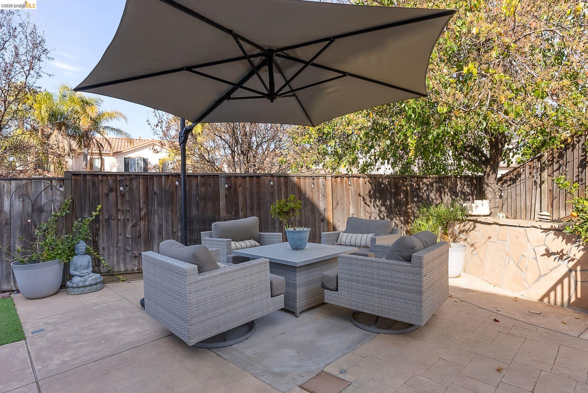 606 Ralston Court Brentwood, CA 94513 - Photo 28 of 32 a patio with patio a table and chairs under an umbrella