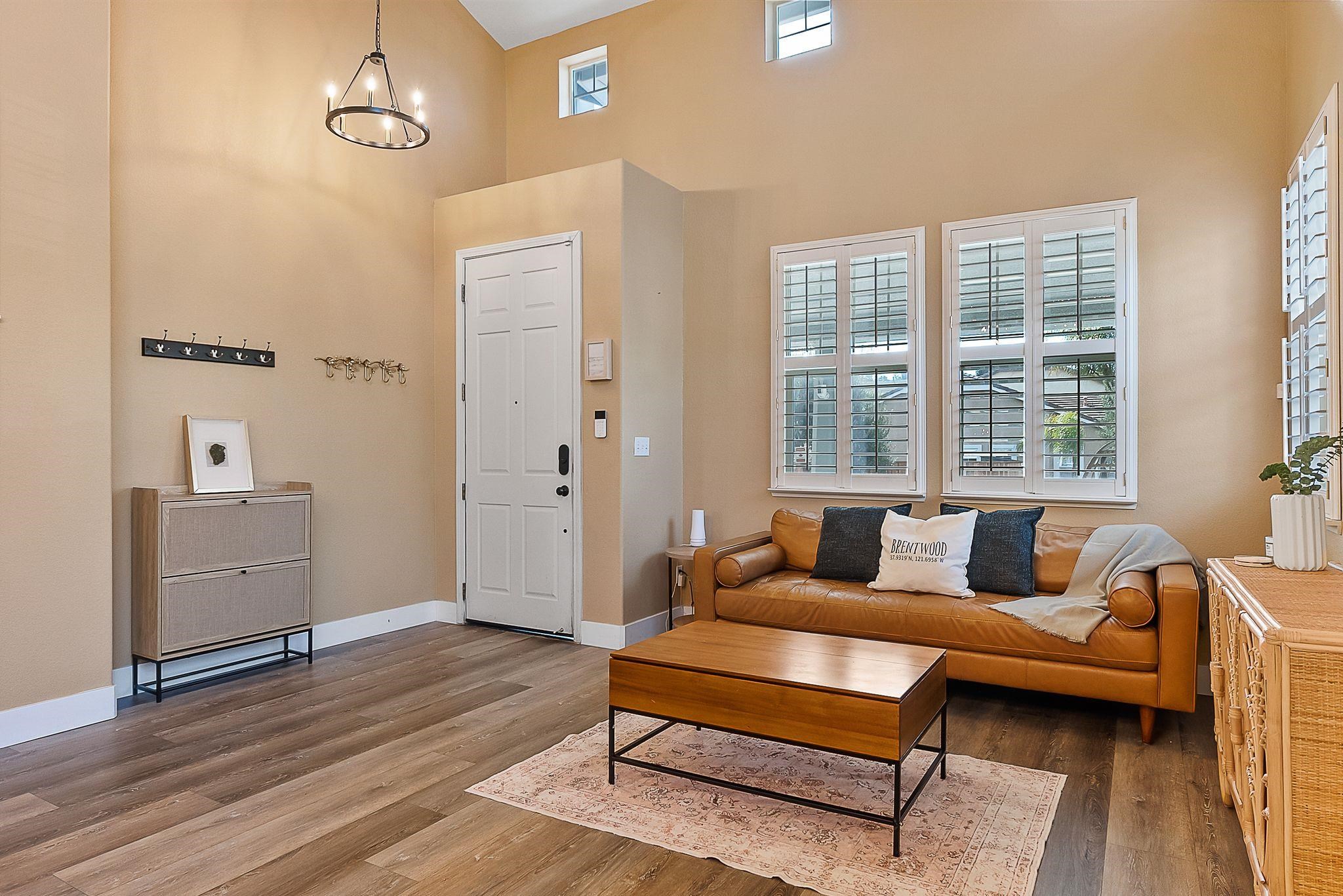 606 Ralston Court Brentwood, CA 94513 - Photo 5 of 32 Living area featuring wood finished floors and a chandelier