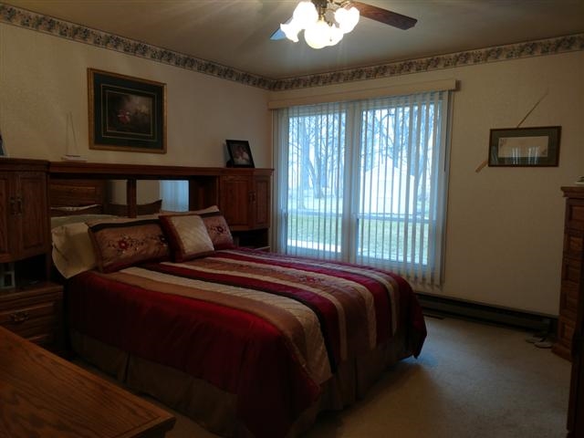 702 Westmore Road Davis, IL 61019 - Photo 10 of 15 a bed sitting in a bedroom next to a window